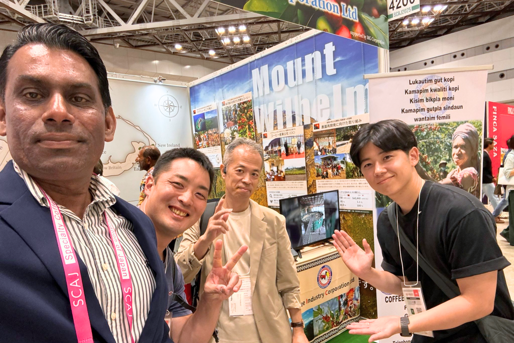 Visitor engagement at the Papua New Guinea specialty coffee booth at SCAJ 2025